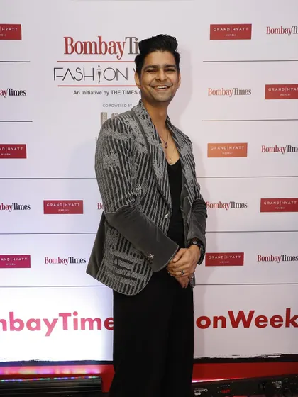 Vinay Mishra at Bombay Times Fashion Week in the same grey velvet coat. This look shows its versatility, styled here for a fashion-forward event with an all-black base to let the embroidery shine.