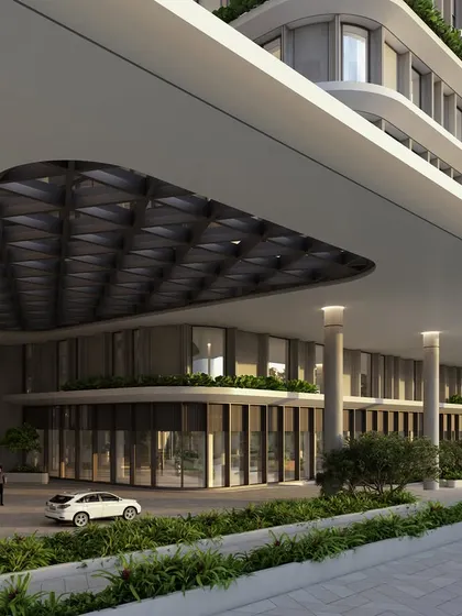 The grand, covered drop-off area of the corporate headquarters. The sweeping curves of the canopy and the transparent glass facade create a bold statement, engineered to inspire from the moment of arrival.