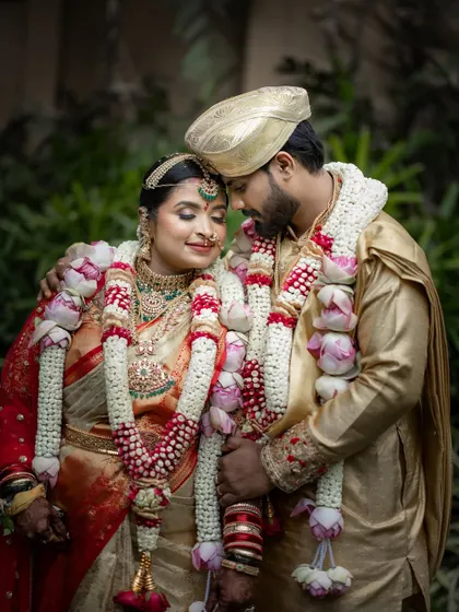A close, intimate portrait of the couple after their ceremony. Adorned with beautiful lotus garlands, their happy and content expressions tell the story of a successful union.