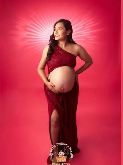This sequined red gown against a matching red backdrop is for the mama who wants a bold and glamorous look. The dramatic lighting makes her absolutely shine.