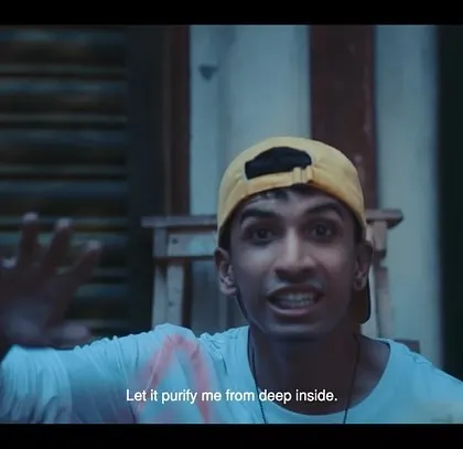 A rapper performs in the streets of Kolkata in this still from the East Bengal FC ad. His cool, casual style connects with the local youth culture.