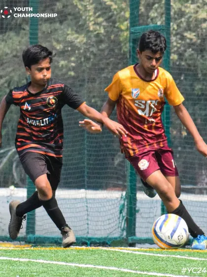 The thrill of the game. Players from both teams compete for the ball on a Sunday match day.