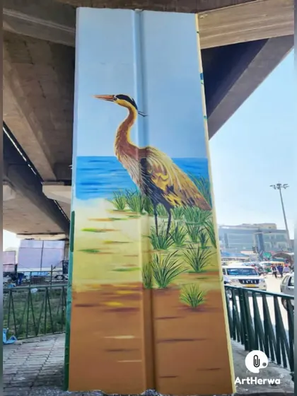The completed heron mural, showing the bird standing peacefully by the water. This serene image brings a moment of calm to a busy urban environment.