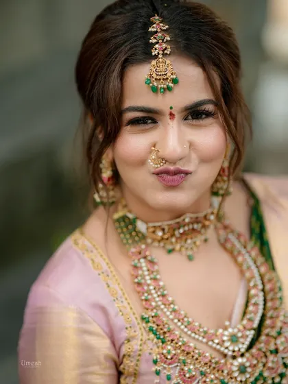 A playful and cute close-up, capturing the client's happy expression and the beauty of her makeup and jewellery.