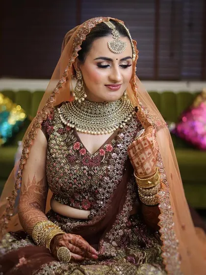A full view of a contemporary bridal look. The soft, glowing makeup complements the intricate outfit without overpowering it, perfect for a sophisticated wedding ceremony.