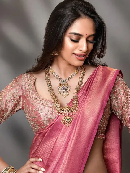 A candid-style bridal shot that captures a moment of joy. This approach brings a natural and relatable feel to bridal lookbooks, highlighting the beauty of the attire in a more personal way.