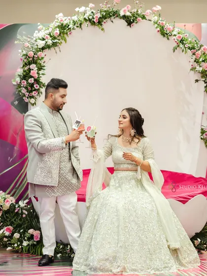 A cute moment with the couple toasting with customized drinks at their Mehendi.