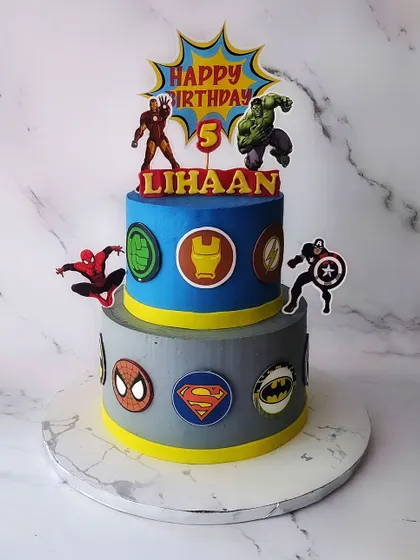Make way for the Super Heroes! A two-tier vanilla cake for Lihaan's 5th birthday, featuring logos and characters from the Avengers, Superman, and Batman.