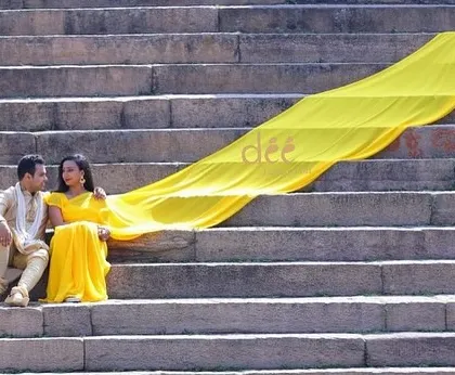 A beautiful pre-wedding shoot on ancient steps, with our long yellow trail saree adding a vibrant splash of color.