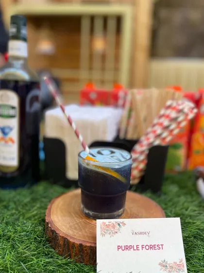 The Purple Forest is a visually striking mocktail with a deep, fruity flavor. It adds a touch of elegance and mystery to your event's drink menu.