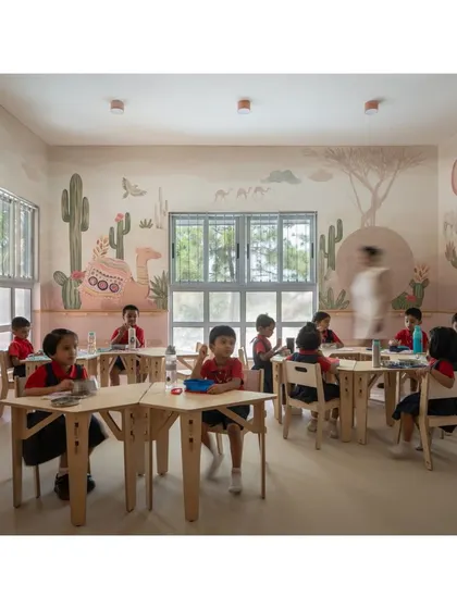 Children in their element within the desert-themed classroom. The space is designed to be interactive and engaging, with every detail, from the furniture to the wall art, contributing to an immersive learning experience.