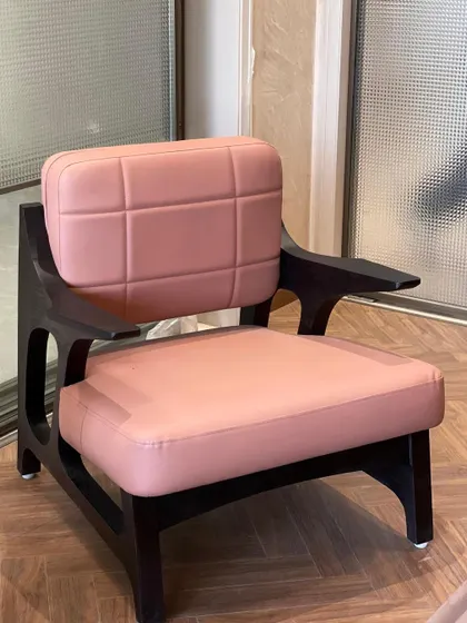 A full front view of the pink Japandi armchair. The contrast between the dark, burnt wood frame and the soft pink upholstery is both striking and elegant.