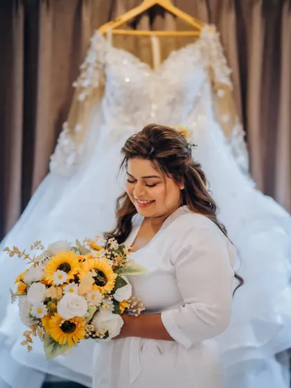 Meet Diana, a true fireball of a person. Here she is before getting into her gown, holding her sunflower bouquet that perfectly matches her vibrant personality.
