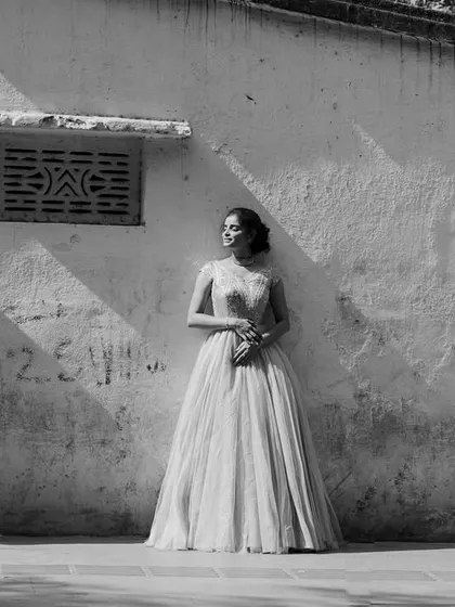 A timeless black and white composition. The play of harsh sunlight and shadow on the wall adds a dramatic, artistic feel to this urban couple's portrait.
