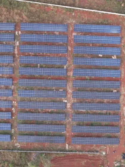 A top-down drone shot of the 1.3 MW solar farm, illustrating the precise layout and scale required for utility-grade power generation. Each row is optimized for maximum sun exposure and energy output.