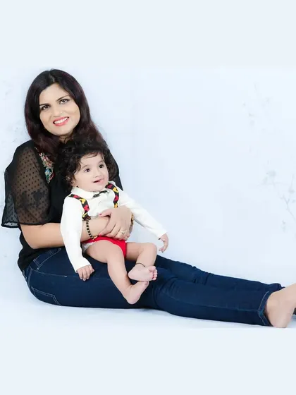 A mother and her baby share a sweet moment together. The simple, bright background keeps the focus on their loving connection.