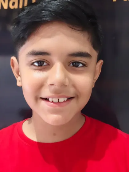 A happy young client showing off his fresh new haircut.