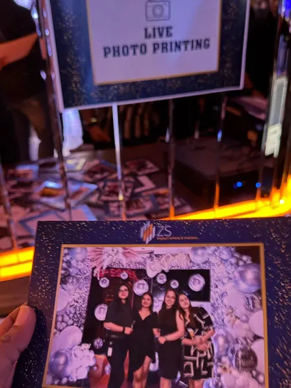 A great party favor idea is a live photo printing booth. Guests can take home a branded photo from the event, creating a lasting memory of the fun they had.