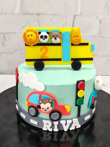 The details make the cake. This angle shows the handcrafted fondant animals and the personalized name, making it a truly special birthday cake for Riva.
