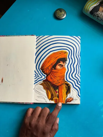 Here I am pointing out a detail in the finished artwork. Every part of this hand-drawn illustration, from the folds of the fabric to the hypnotic background, is done by hand.