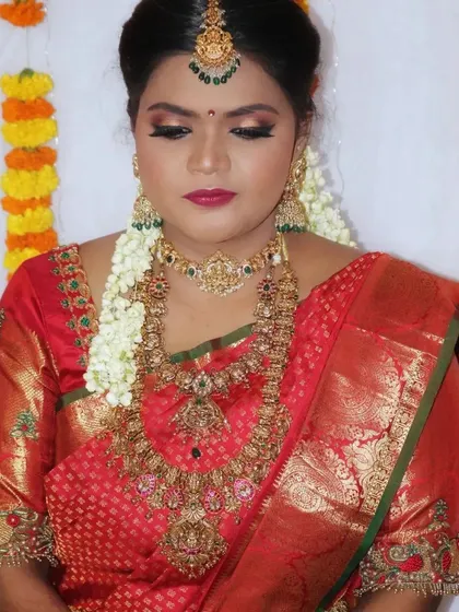 Different angles of a classic red saree look, showcasing the intricate details of the jewelry and the flawless finish of the makeup.