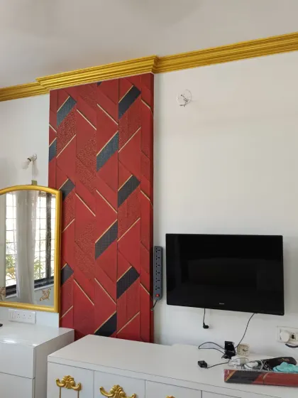 Don't be afraid to go bold. This installation features a striking red and black geometric wallpaper that acts as a powerful focal point in the bedroom. It’s a great example of how a dynamic pattern can energize a room and reflect a client's personality.