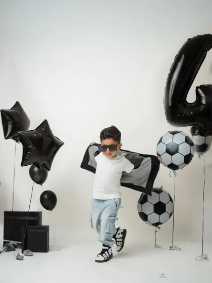A dynamic action shot of the birthday boy, running with a cape-like jacket. I love capturing the energy and personality of older kids during their milestone sessions.