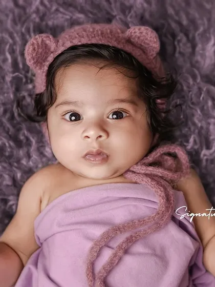 A duplicate of image 54, capturing the expressive eyes of an older baby.