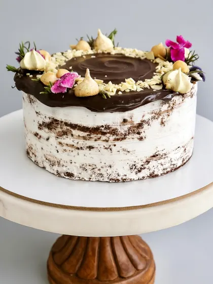 For those who love a bold and nutty cake, I created the Chocolate Hazelnut Naked Cake. It has a decadent chocolate sponge, dark chocolate ganache, a layer of Nutella, and is topped with roasted hazelnuts and almonds for a wonderful crunch.