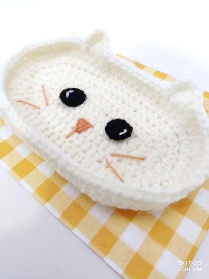 The cat-faced trinket dish shown on its own, highlighting the cute embroidered face details.