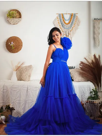 A full-length shot of the royal blue one-shoulder gown in my studio. The tiered skirt and large floral detail make it a true statement piece.