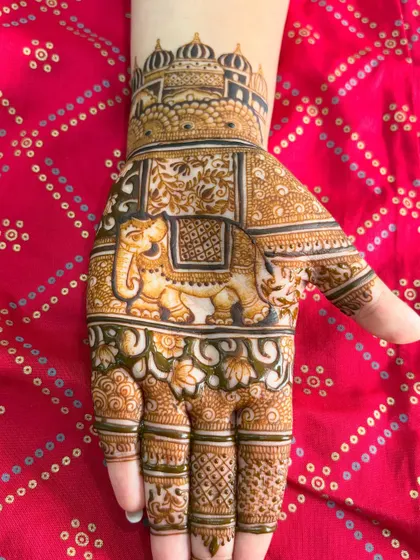 A classic design for the palm featuring a grand, decorated elephant under a royal archway. The fingers are detailed with delicate, traditional patterns.