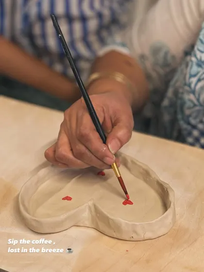 A moment of quiet focus during our Valentine's workshop. A student carefully paints tiny red hearts onto a handmade, heart-shaped trinket dish, pouring love into every detail.
