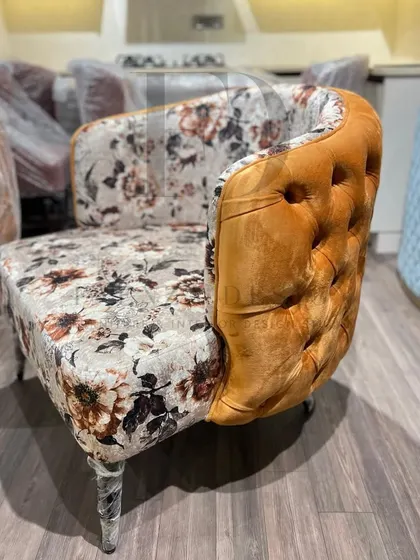 A showcase of my versatile accent chair designs. This includes a green velvet chair with a tufted back, and another model combining floral-print fabric with a mustard-yellow tufted back.