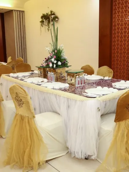 Creating the perfect ambiance with beautifully decorated dining tables. The elegant chair covers and table settings complement our exquisite food service for a complete experience.
