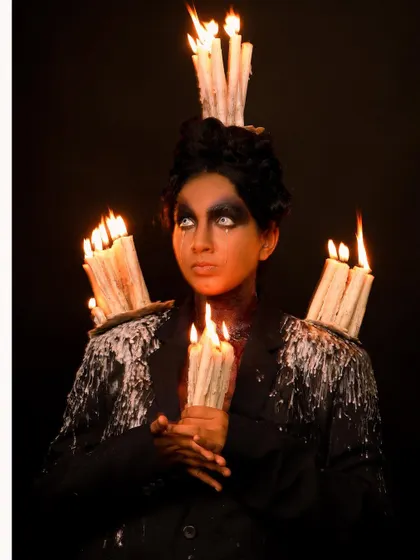 A dark fantasy concept brought to life with practical effects. This hauntingly beautiful portrait features a model adorned with lit candles, creating a truly unique and artistic image.