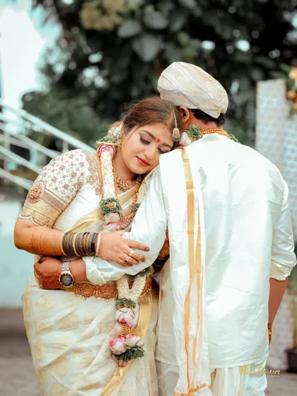 A comforting embrace from behind. This candid photo captures a quiet, supportive moment between the bride and groom on their wedding day.