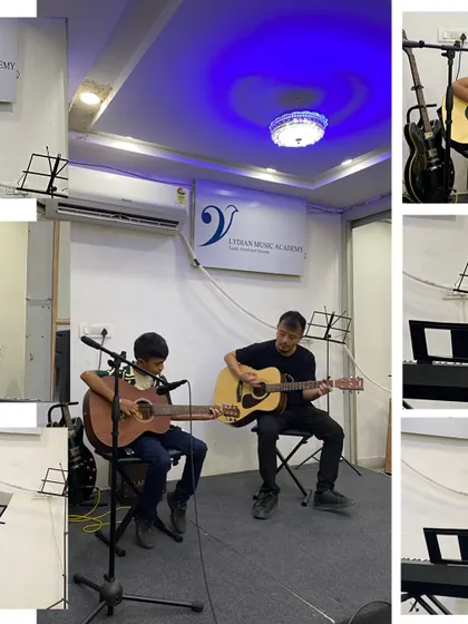 A guitar student performs a duet with his instructor. Our teachers often accompany students to provide support and guidance during their first performances.