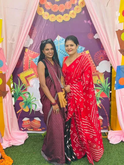 Another moment from the event, showing how the red and black combination of my saree creates a striking visual contrast.