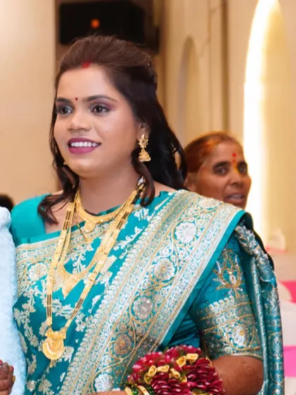 A candid photo of the bride at her reception, looking happy and radiant.