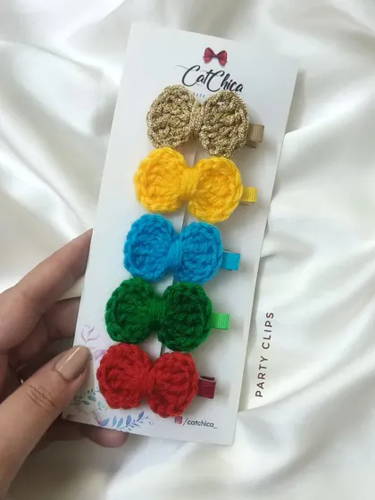 A set of five mini crochet bow clips in a rainbow of colors, perfect for toddlers and girls.