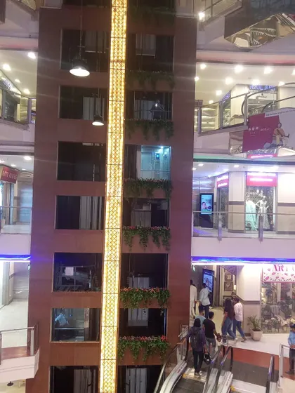 A full view of the mall's central elevator shaft, decorated with our artificial greenery on multiple levels.