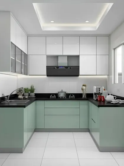 This U-shaped kitchen in a soft mint green offers ample counter space and storage. The high-gloss cabinets and white tiled floor make the space feel bright and spacious, while the false ceiling adds a modern touch.