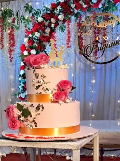 The engagement cake perfectly complements the red and white decor theme. We ensure every element on the stage looks coordinated.