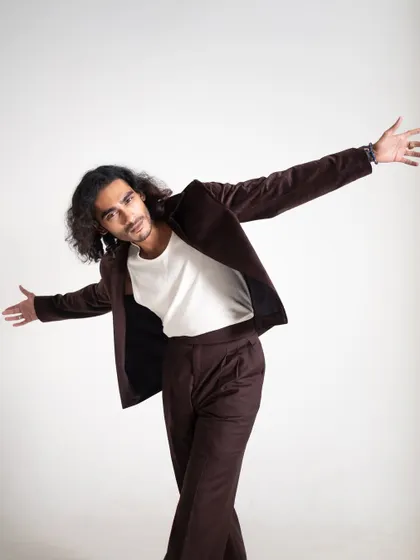 An expressive, open-armed pose that adds personality and dynamism to the studio shoot.