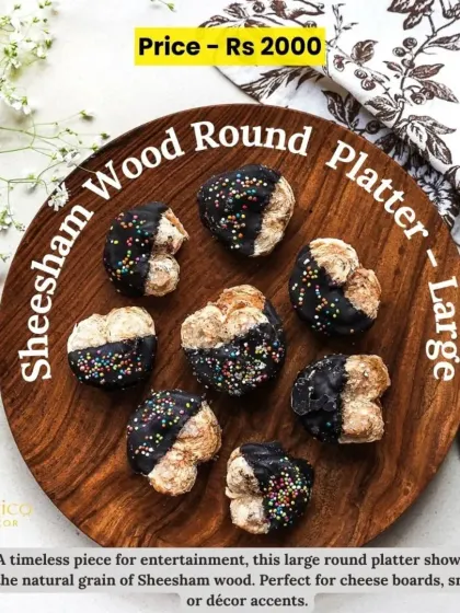 This large round sheesham wood platter is a timeless piece for entertainment, showcasing the natural grain of the wood. It's perfect for cheese boards or snacks.