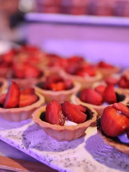 A tray of our fresh strawberry tarts. The combination of the crisp pastry shell, creamy filling, and fresh, juicy strawberries is a classic that never fails to please.