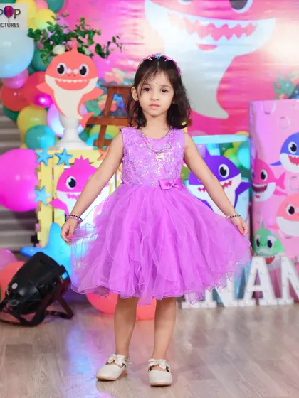 A magical 'Mermaid' themed birthday party, with shimmering blue and green decor, seashell props, and mermaid cutouts, creating an enchanting underwater world.