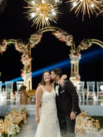 A sweet, romantic moment during the first dance. The starburst chandeliers and soft lighting create a dreamy atmosphere for the couple.