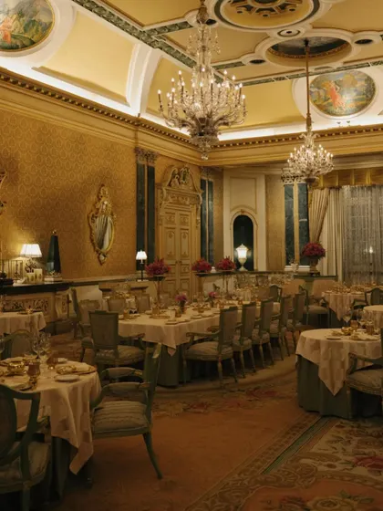 The opulent dining hall at Rambagh Palace, set for an intimate royal feast. The golden walls and crystal chandeliers exude pure luxury.